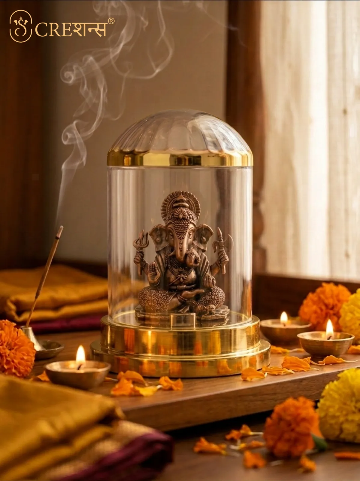 Gold Ganesh cloche on a festive table with marigolds, diyas and incense