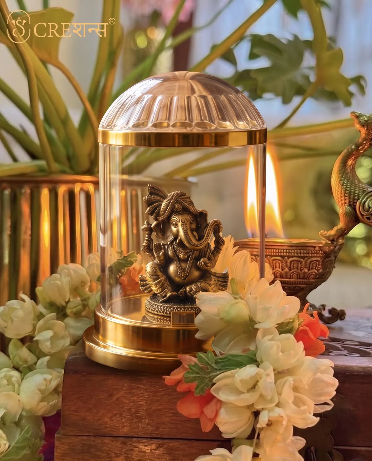 Rose-gold Ganesh cloche on a garden bench with bougainvillea