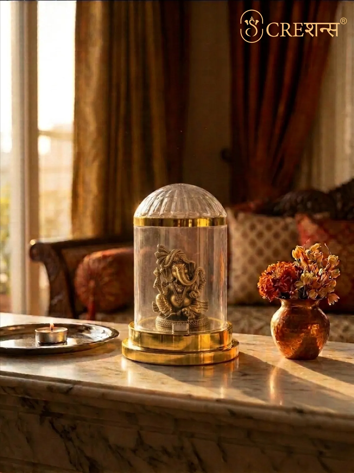 Gold Ganesh cloche on a marble console with flowers