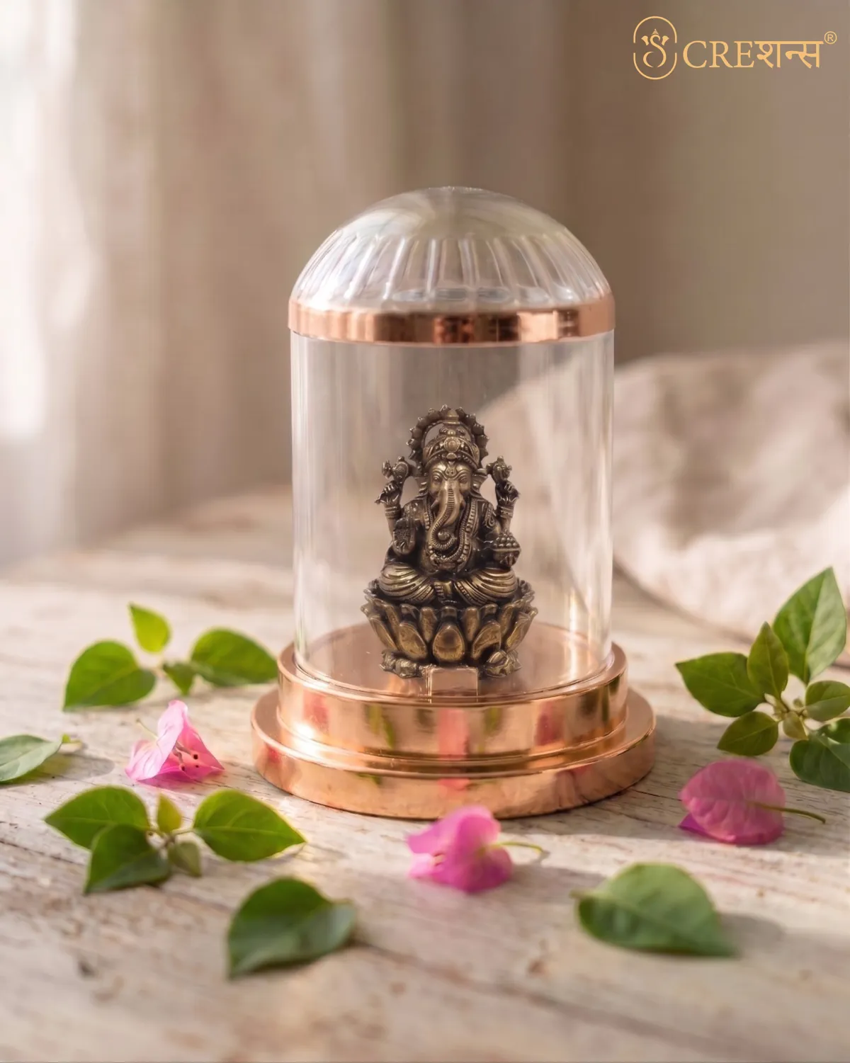 Rose-gold Ganesh cloche on a leather car seat in soft light